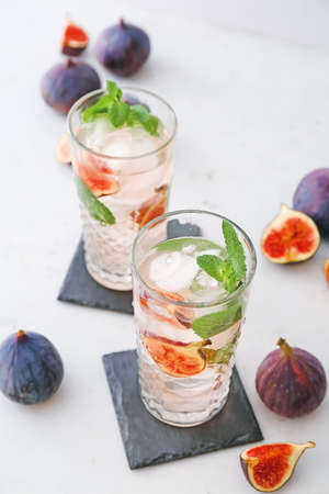 Composition with tasty fig lemonade on light backgroundの写真素材