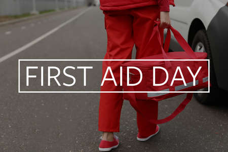 Female paramedic with bag near ambulance car. World first aid dayの写真素材