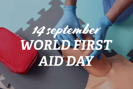 Instructor demonstrating CPR on mannequin. World first aid day