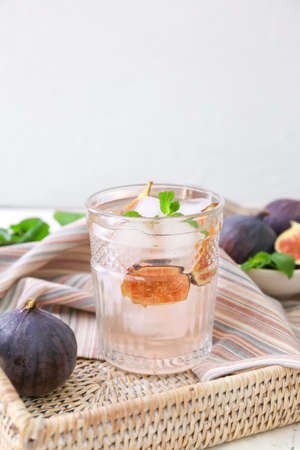 Composition with tasty fig lemonade on light backgroundの写真素材
