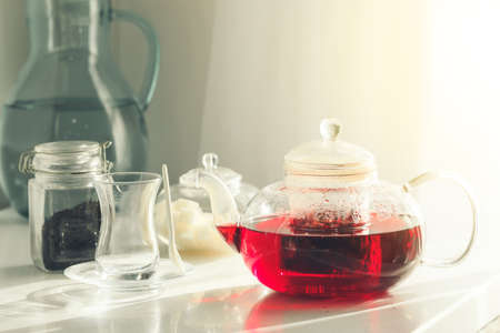 Glass teapot with hot tea on tableの写真素材
