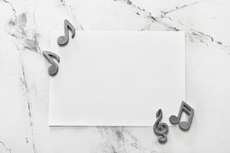 Empty paper sheet with music notes on white backgroundの写真素材