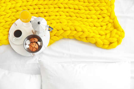 Tray with tasty breakfast on bedの写真素材