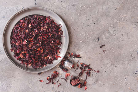 Plate with dry hibiscus tea on tableの写真素材