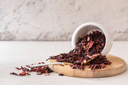 Bowl with dry hibiscus tea on tableの写真素材