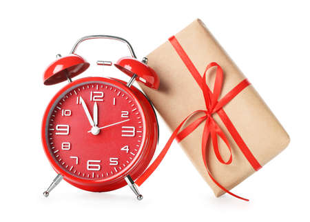 Alarm clock and Christmas gift isolated on whiteの写真素材