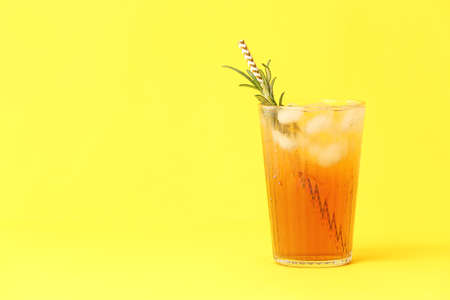 Glass of cold black tea with lemon on color backgroundの写真素材