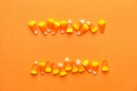 Tasty candies for Halloween on color backgroundの写真素材