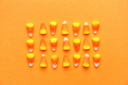 Tasty candies for Halloween on color backgroundの写真素材