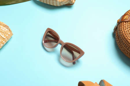 Stylish sunglasses on color background