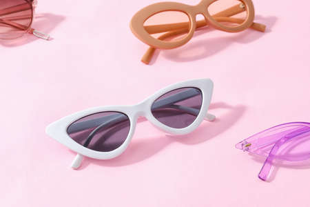 Stylish sunglasses on color background