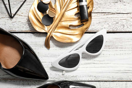 Set of female accessories and sunglasses on wooden backgroundの写真素材