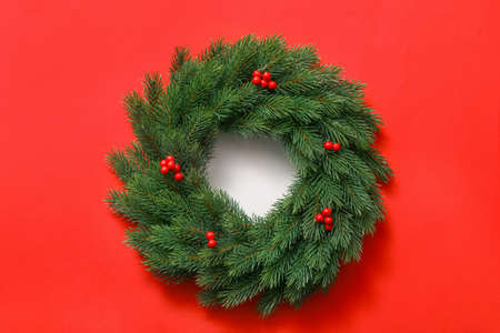 Beautiful Christmas wreath on color backgroundの写真素材