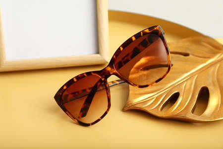 Stylish female sunglasses on tableの写真素材