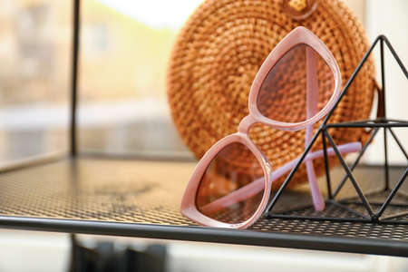 Stylish female sunglasses on shelfの写真素材