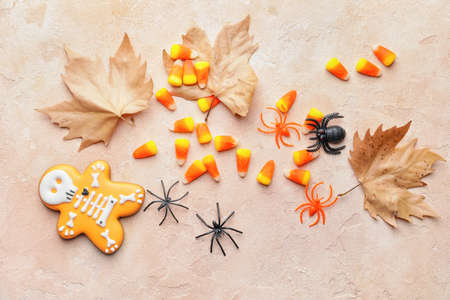 Halloween composition with tasty candy corns on color background