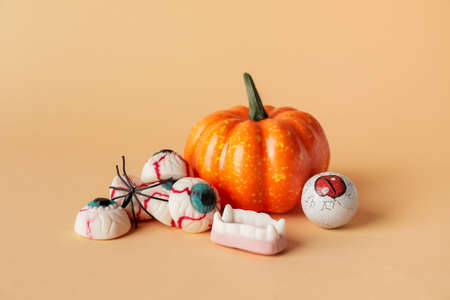 Tasty treats for Halloween on color background