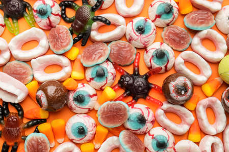 Tasty treats for Halloween on color backgroundの写真素材