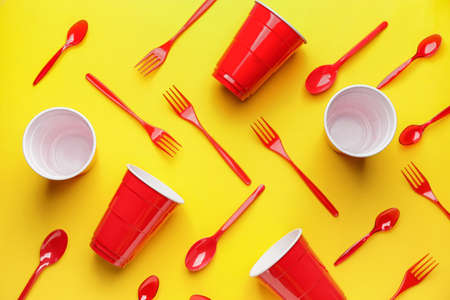 Plastic tableware on color backgroundの写真素材