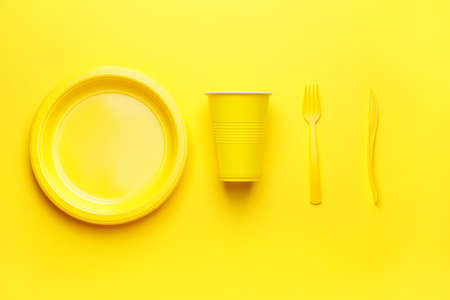 Plastic tableware on color backgroundの写真素材