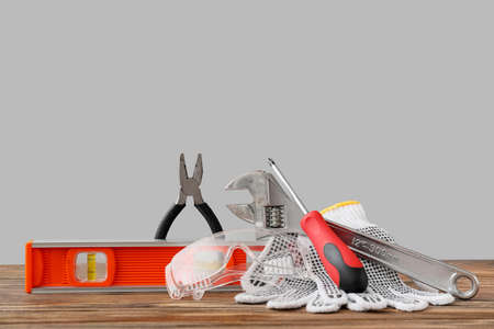 Construction tools on table against gray backgroundの写真素材
