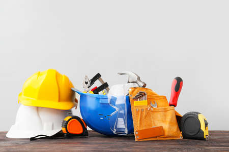Construction tools on table against gray background