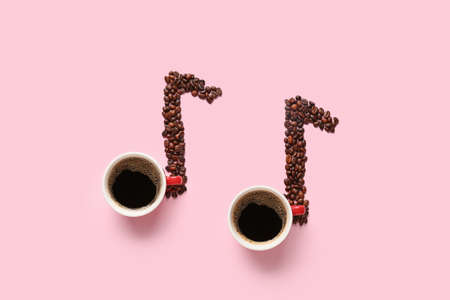 Music notes made of cups of coffee and beans on color backgroundの写真素材