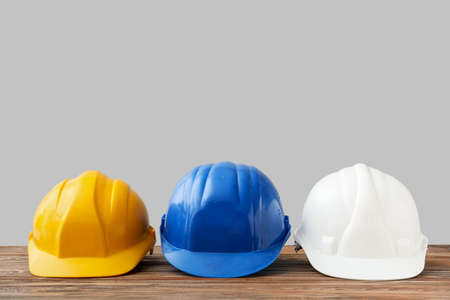 Hardhats on table against gray backgroundの写真素材
