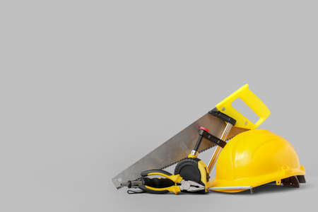 Hardhat and construction tools on gray backgroundの写真素材