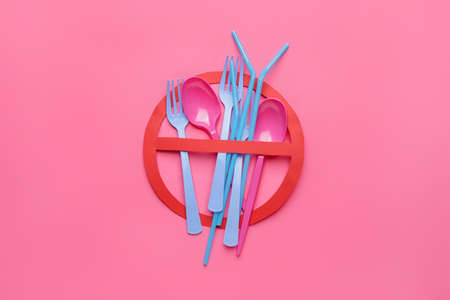Plastic tableware and stop sign on color backgroundの写真素材