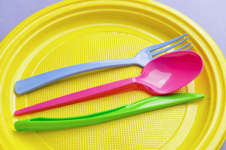 Plastic tableware on color background, closeupの写真素材