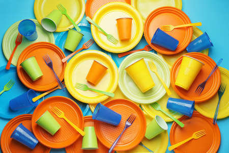 Plastic tableware on color backgroundの写真素材