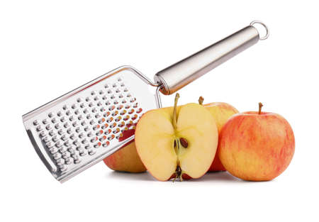 Metal grater and apples on white backgroundの写真素材
