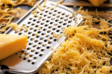 Metal grater and pile of cheese, closeupの写真素材