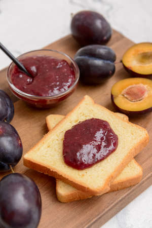 Composition with delicious homemade plum jam on light backgroundの写真素材