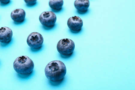 Tasty ripe blueberry on color backgroundの写真素材