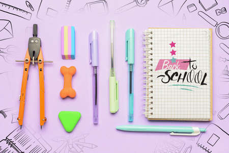 Set of stationery and notebook with text BACK TO SCHOOL on color background