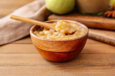 Bowl of tasty pear jam on wooden tableの写真素材