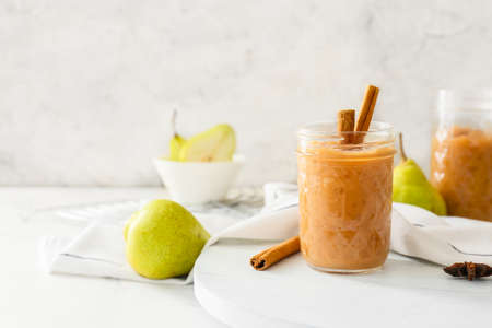 Jar of tasty pear jam on tableの写真素材