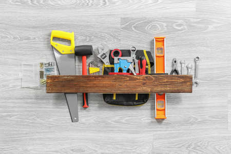 Set of construction tools on gray wooden background
