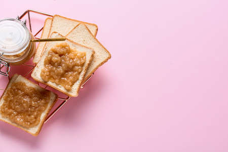 Fresh bread with tasty pear jam on color backgroundの写真素材