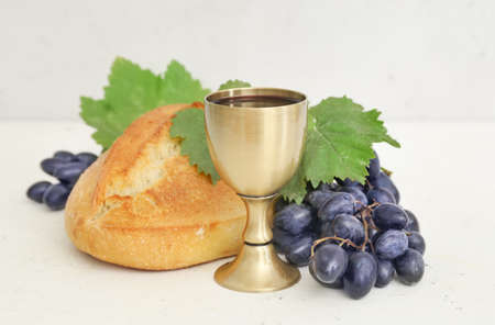 Chalice of wine and bread on white backgroundの写真素材