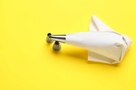 Pastry bag and different tips on color background