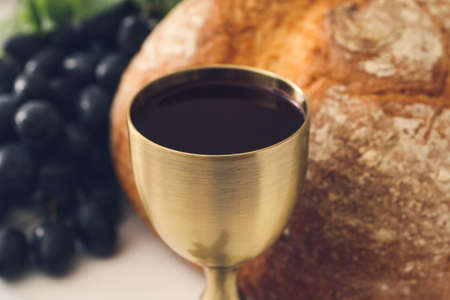 Chalice of wine with bread on table, closeupの写真素材