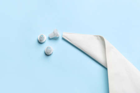 Pastry bag and different tips on color background