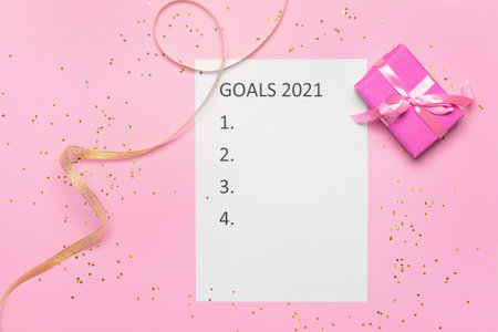 Empty to do list on 2021 year with gift box on color background