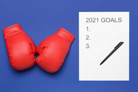 Empty to do list on 2021 year with boxing gloves on color background