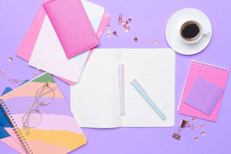 Stationery with cup of coffee on color background