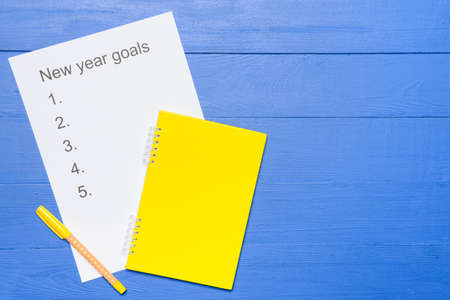 Empty to do list on new year on color wooden background