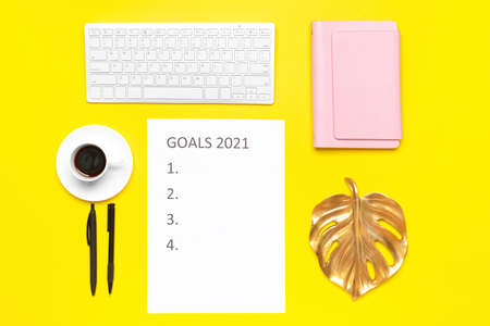 Empty to do list on 2021 year with computer keyboard and cup of coffee on color backgroundの写真素材
